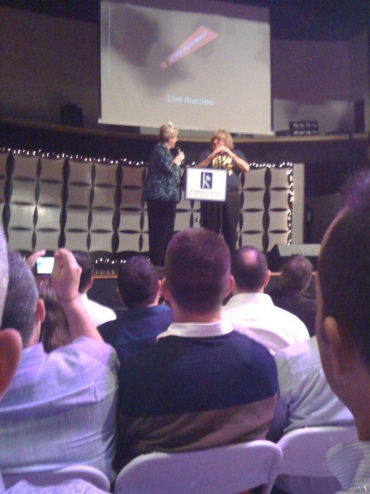 Photo of Bruce Vilanch and auctioneer on stage