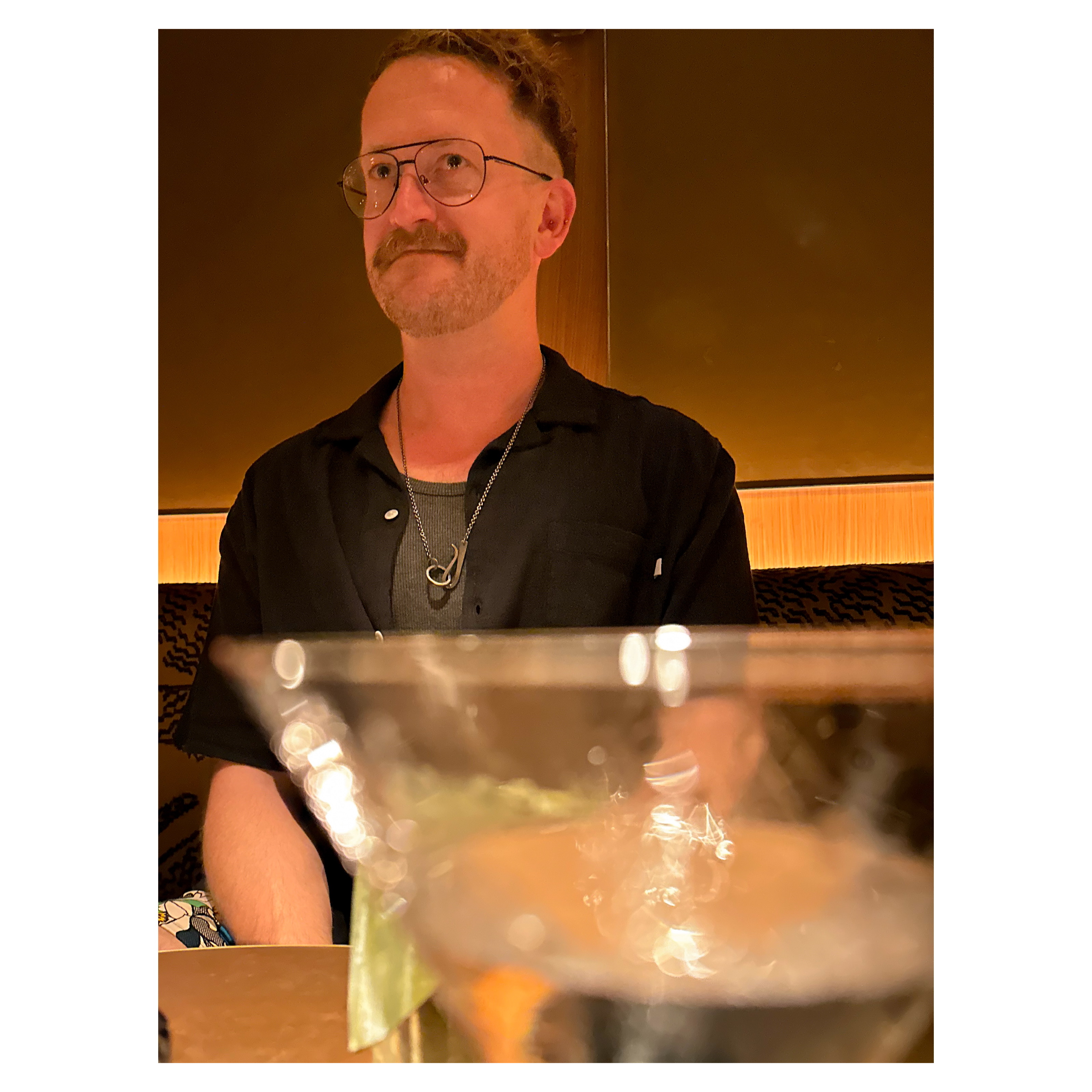 Tom sitting behind a martini glass at Tigre bar